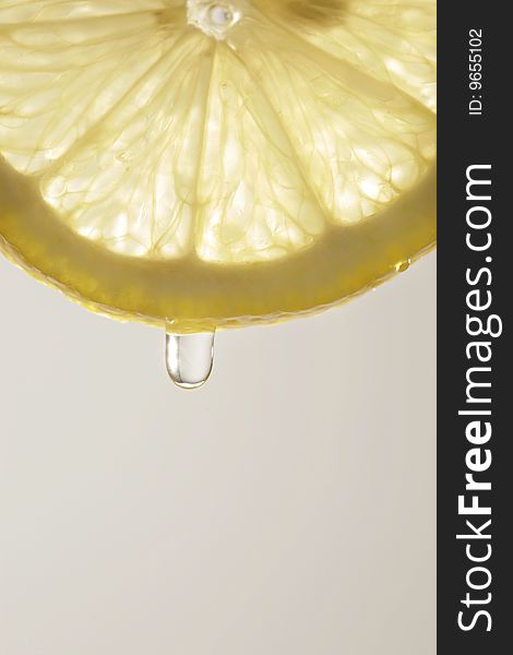 Detail of lemon slice with juice drop