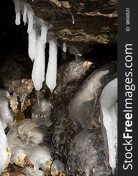 Ice stalagtites under the rock