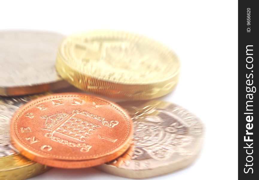 Close-up of UK coins on white with zoom effect