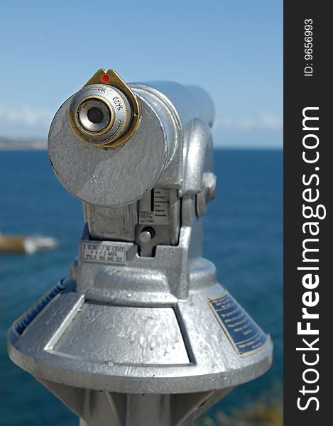 A silver binocular at the coast