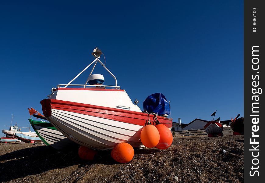 Fishing boats dragged on land, on the west coast of Denmark. White boat.