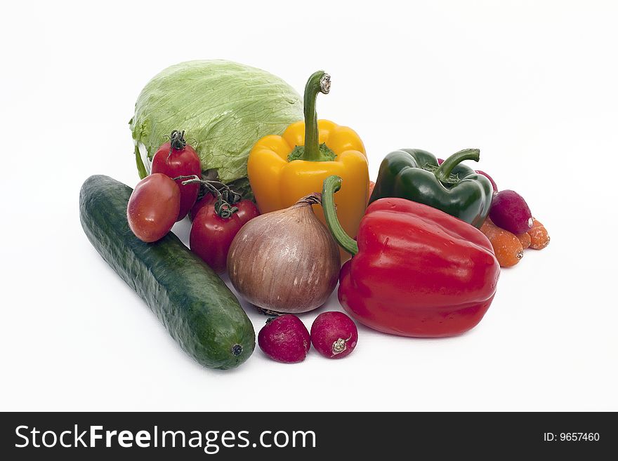 View of several salad vegetables set on a white background. View of several salad vegetables set on a white background.