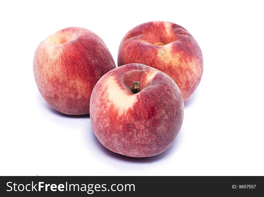 Three peaches on a white background