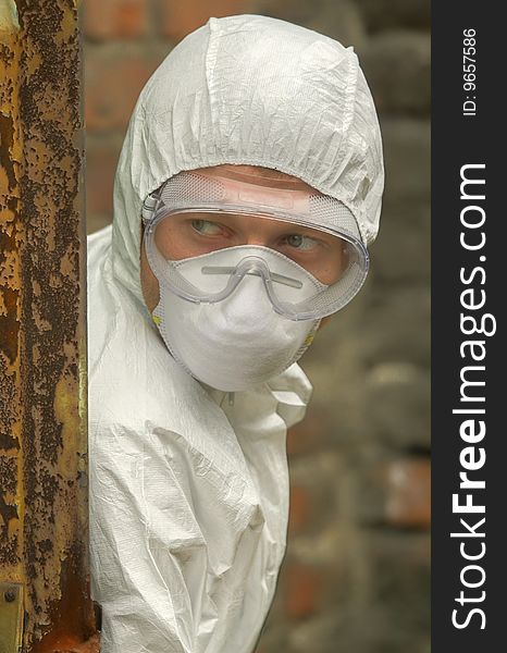 Worker in mask and glasses watching in fear. Worker in mask and glasses watching in fear