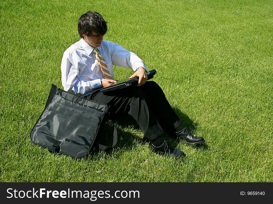 Business Man Sitting In Grass
