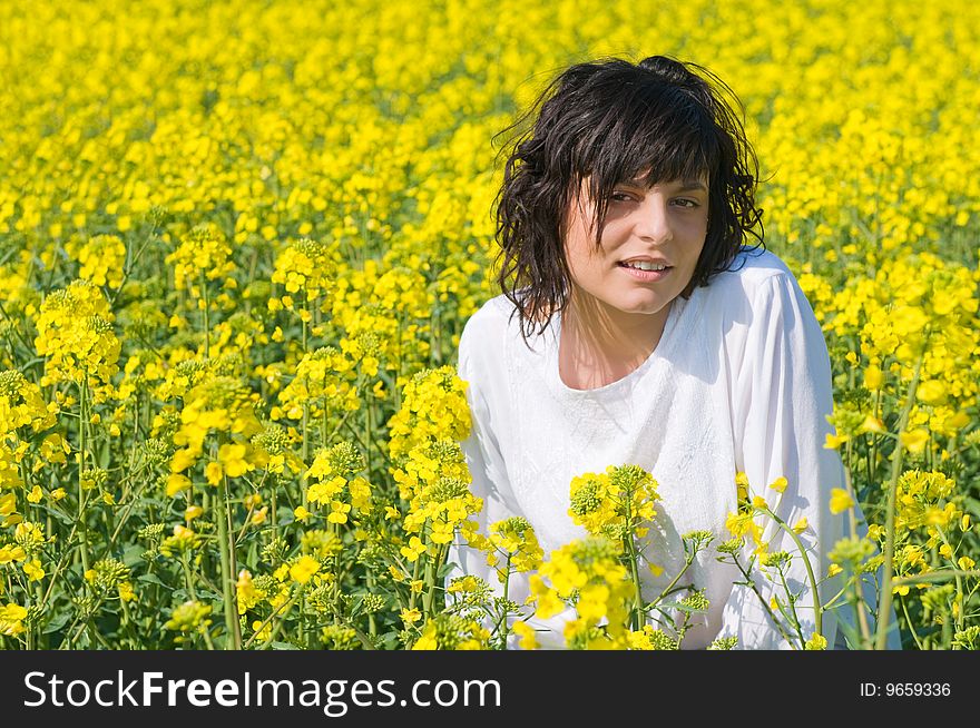 Relaxing girl in the rapeseed yellow field. Relaxing girl in the rapeseed yellow field