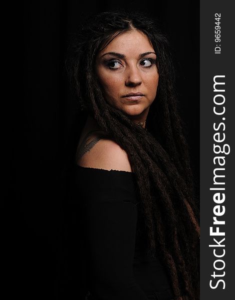 Beautiful woman with dreadlocks over black