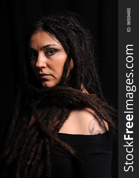 Beautiful woman with dreadlocks over black