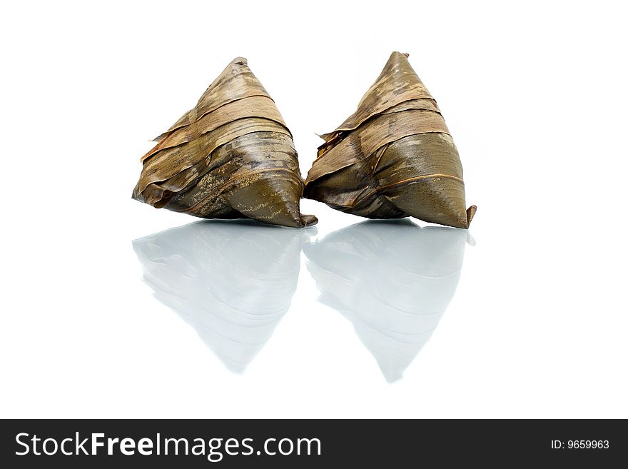 Two rice dumplings (Chinese traditional food) isolated on white background. Two rice dumplings (Chinese traditional food) isolated on white background.