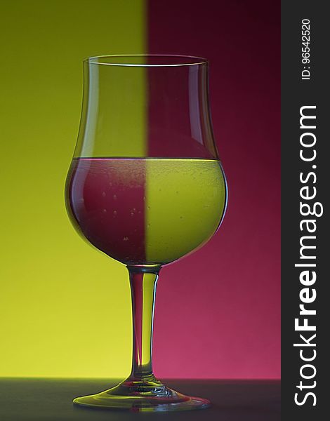 Close-up of Beer Glass Against Colored Background