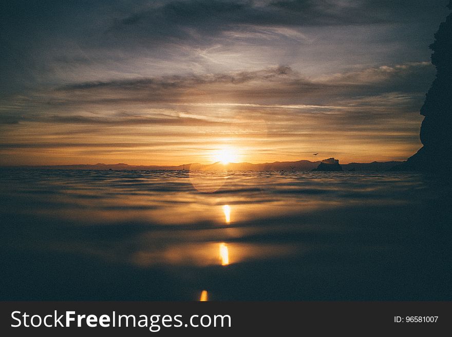 Scenic View of Sea Against Dramatic Sky during Sunset