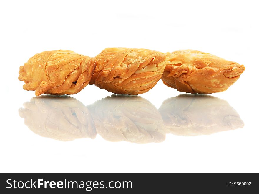 Three curry puffs isolated on white background.