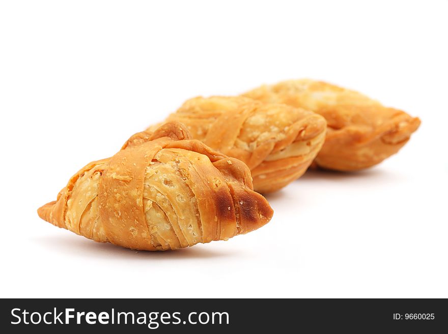 Three curry puffs isolated on white background.