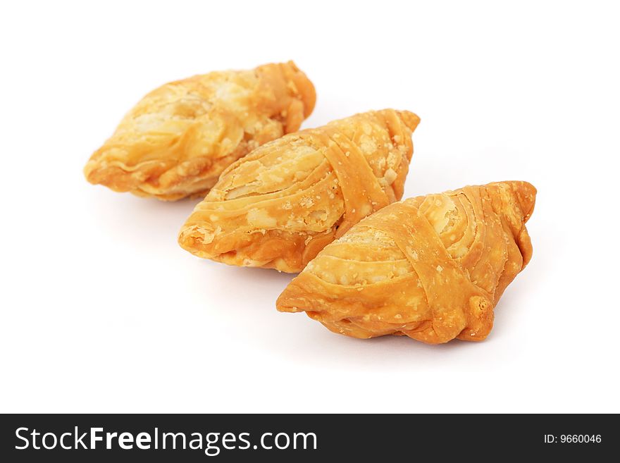 Three curry puffs isolated on white background.