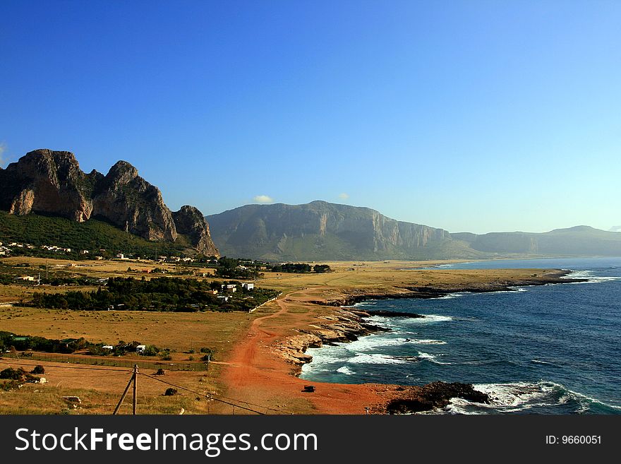 Blue Mediterranean Landscape. Coast, Rocks and sea. Seanson: Summer. Trapani, Island of Sicily. Italy. Blue Mediterranean Landscape. Coast, Rocks and sea. Seanson: Summer. Trapani, Island of Sicily. Italy