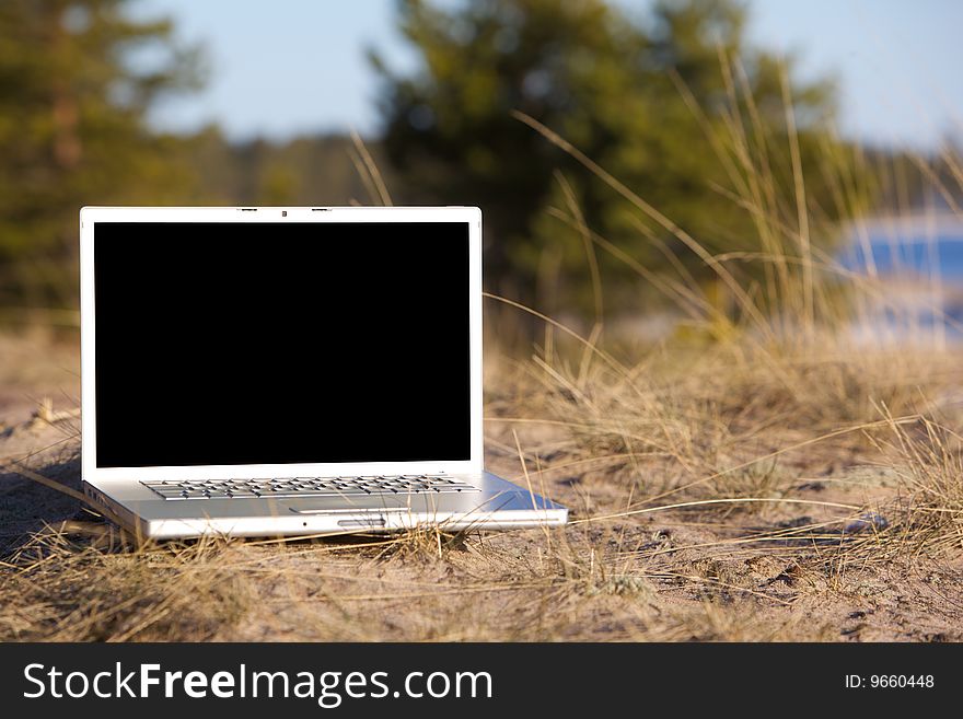 Image of laptop on a nature. Black display with clipping path. Image of laptop on a nature. Black display with clipping path.