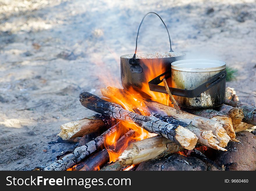Two pot with food on a bonfire. Two pot with food on a bonfire.