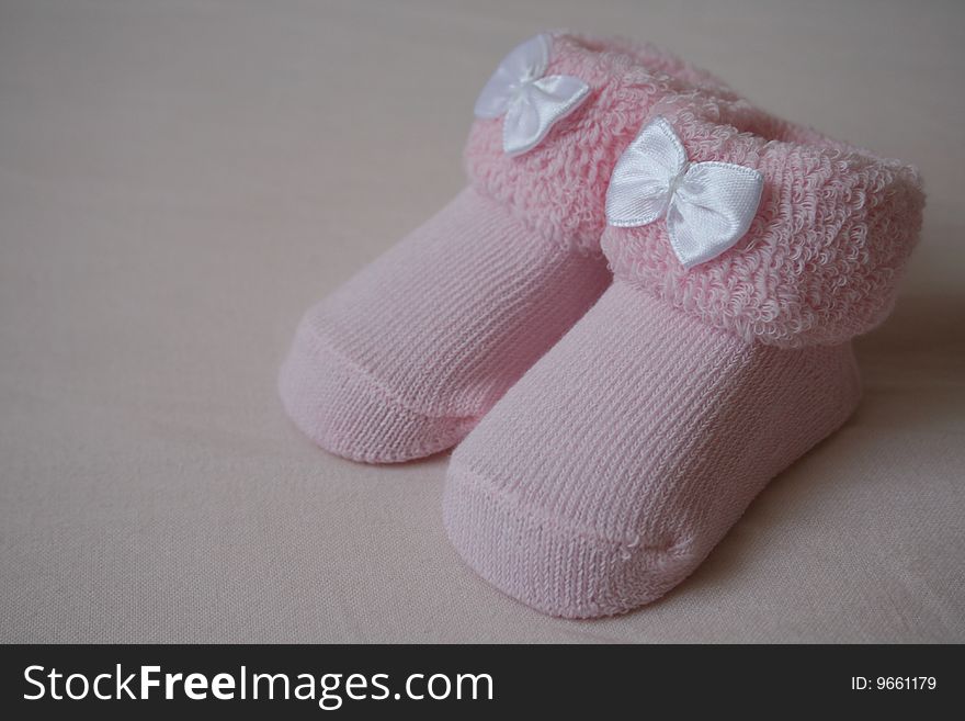 First shoes of newborn girl. First shoes of newborn girl