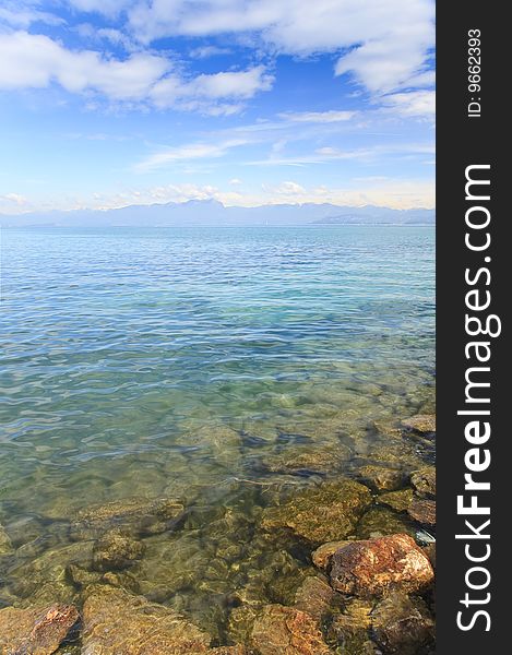 Midday landscape from garda lake, italy. Crystal clear water and warm spring day. Midday landscape from garda lake, italy. Crystal clear water and warm spring day.