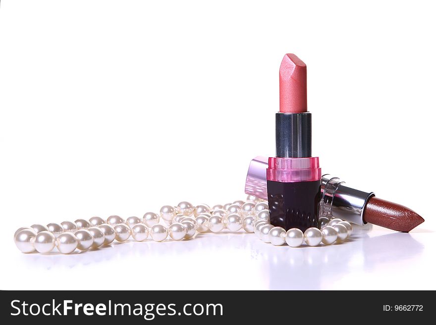 A red lipstick with perl on white