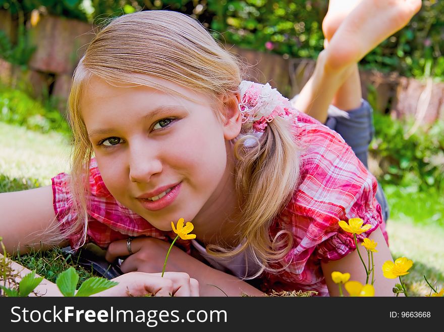 Portrait of a girl with little flower relaxing in the garden. Portrait of a girl with little flower relaxing in the garden