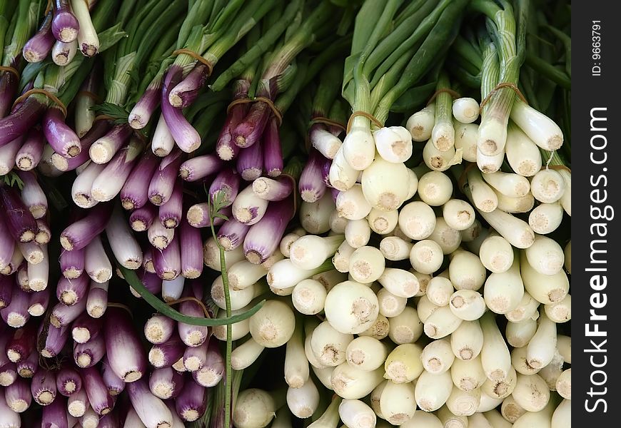 Purple and white welch onions at the market