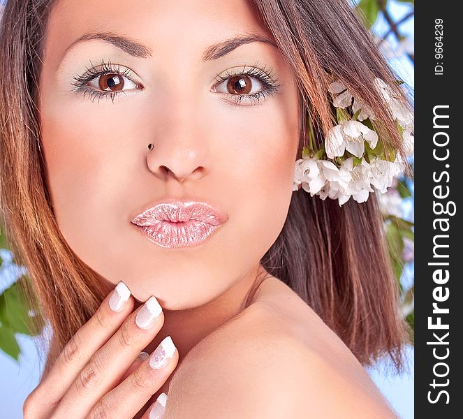 Pretty woman with flowers , studio shot