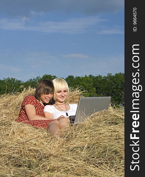 Two Young girl in a stack of hay