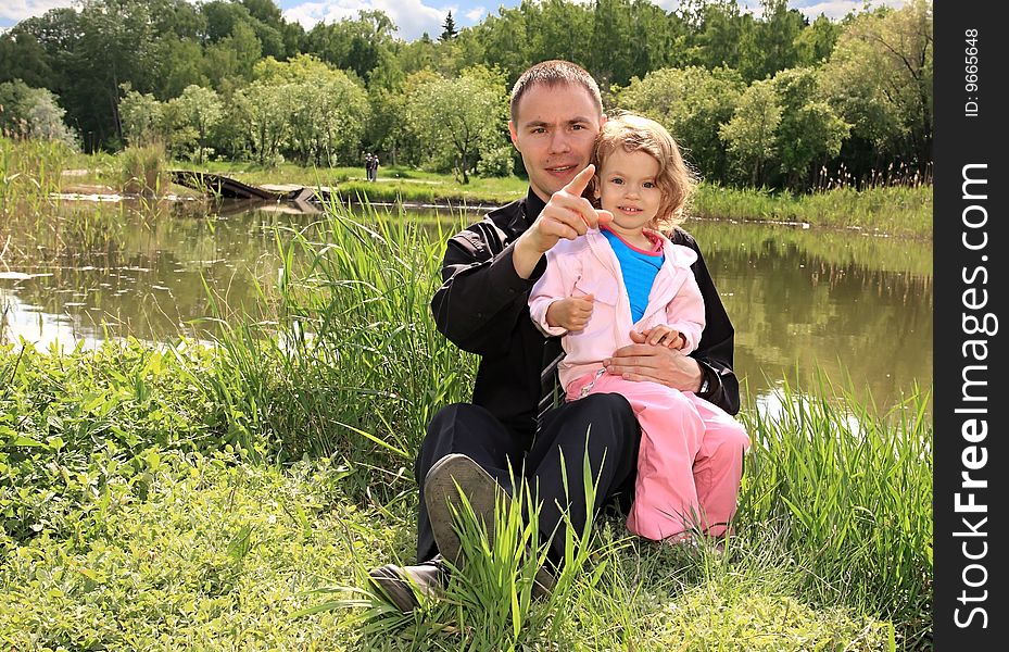 Little girl with a dad on a lake. Little girl with a dad on a lake.