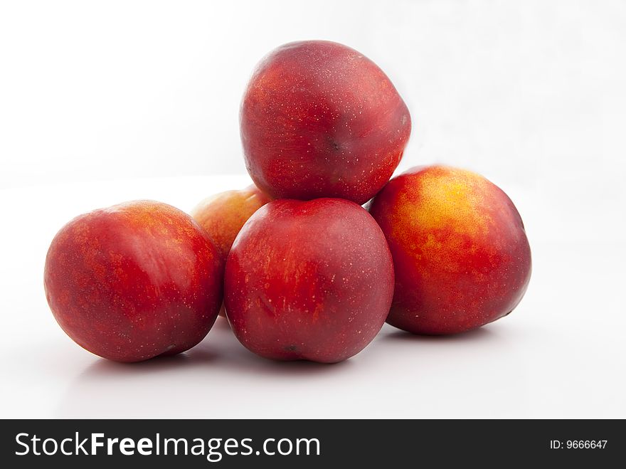 Red and yellow peaches isolated over white background