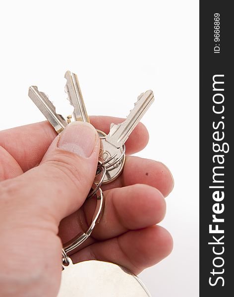 Hand holding keys isolated over white background