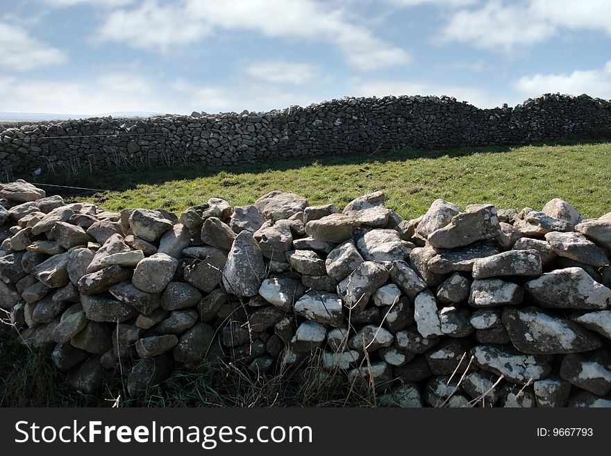 Old irish dry stone walls against a sky background in county kerry ireland. Old irish dry stone walls against a sky background in county kerry ireland