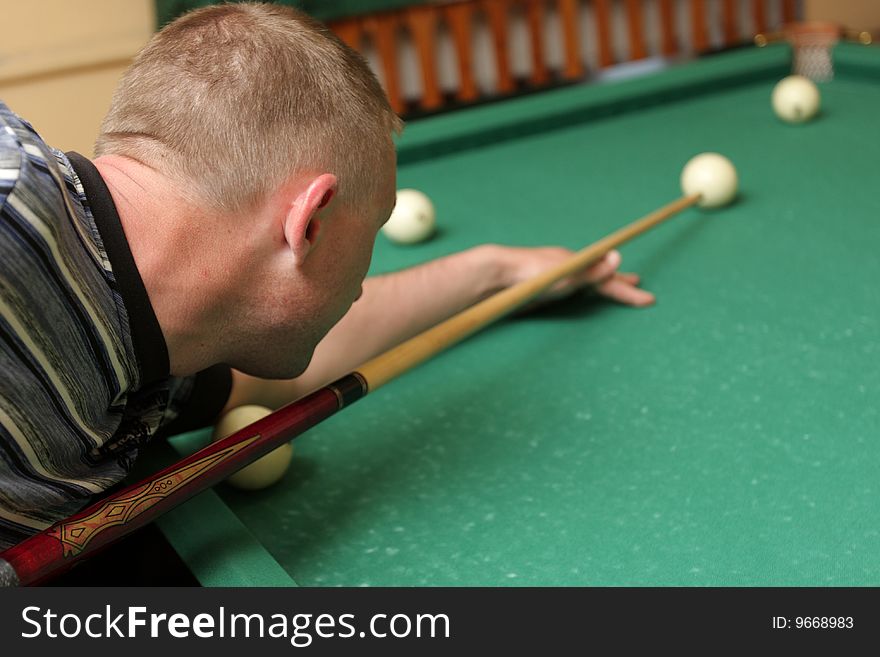 The mid adult man at play in billiards