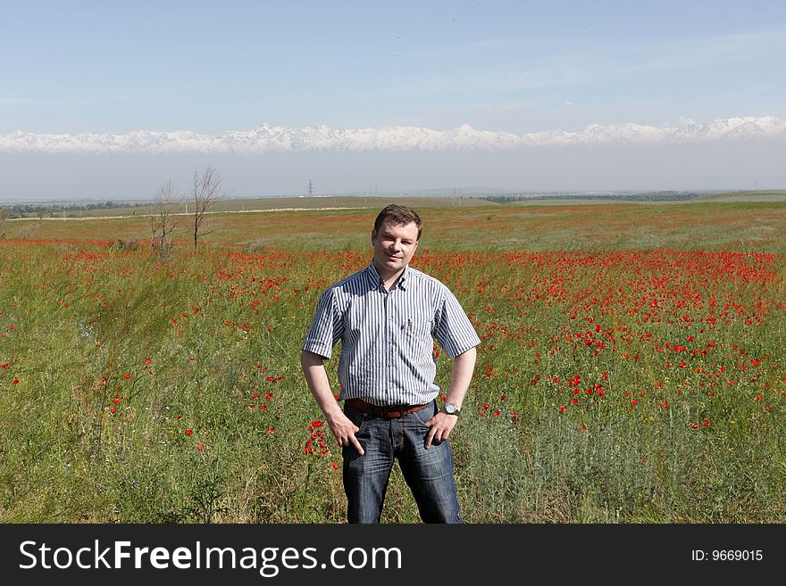 The tourist poses on steppe background in Kazakhstan. The tourist poses on steppe background in Kazakhstan