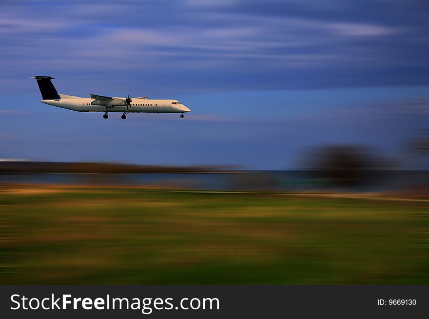 A plane is landing against the scenic background