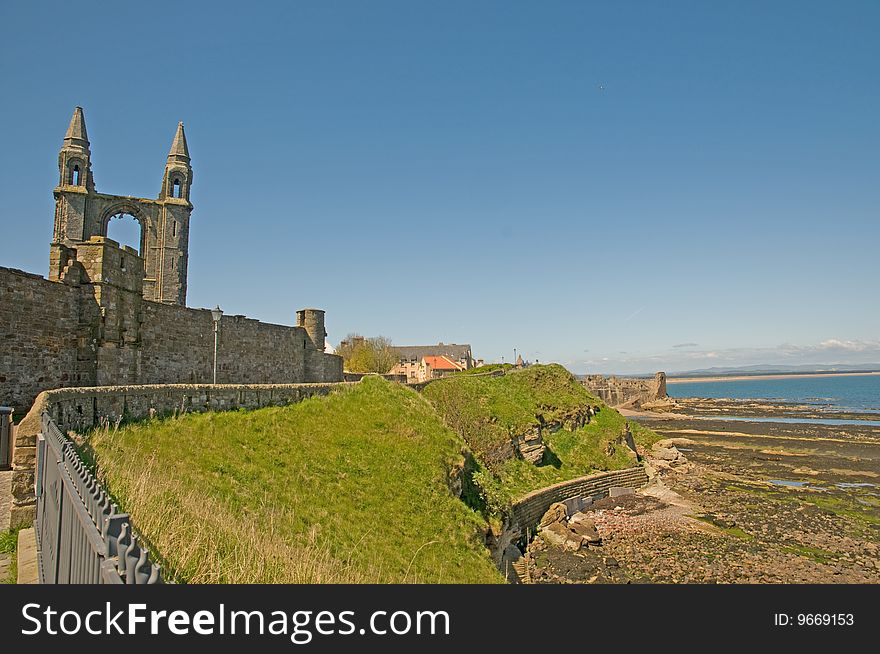 The castle remains of st andrews and the rocky coastline in scotland. The castle remains of st andrews and the rocky coastline in scotland
