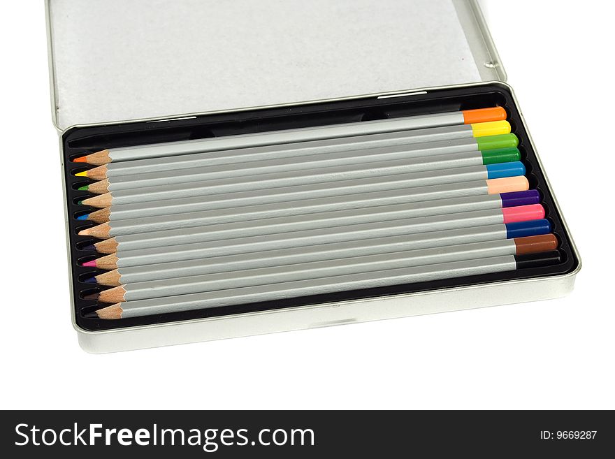 Colored pencils in silver metal box isolated on white