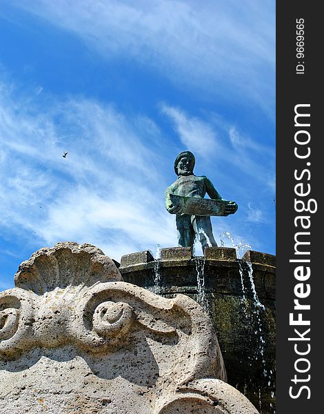 A monument of stone - a fisherman - memorial fountain