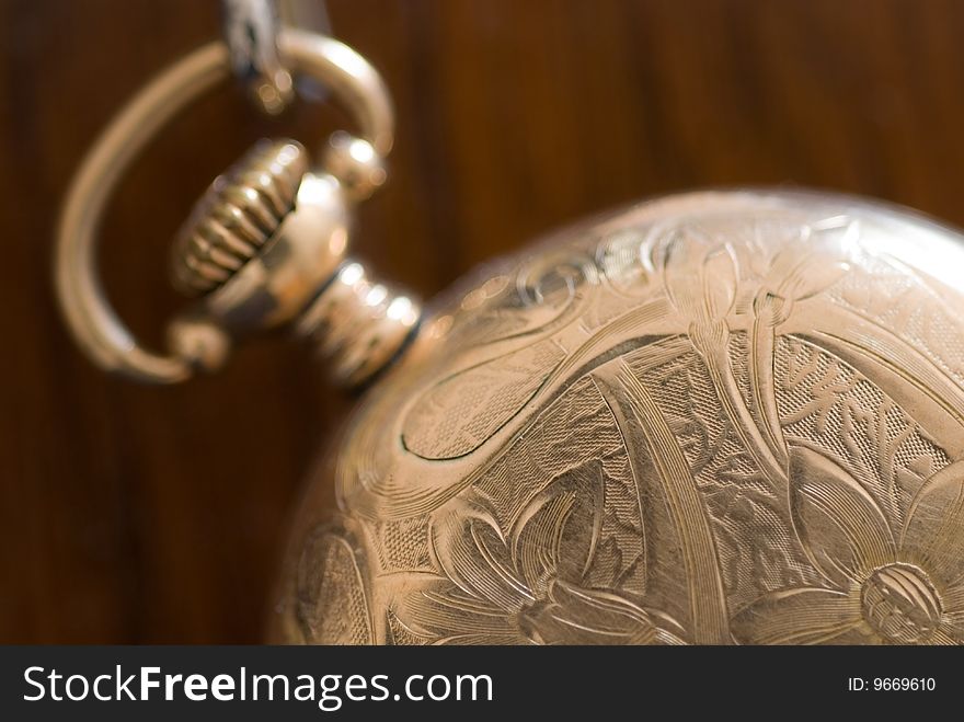 Pocket watch with a chain on purple silk background