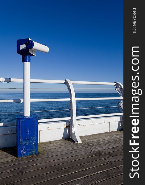Seaside telescope on pier boardwalk