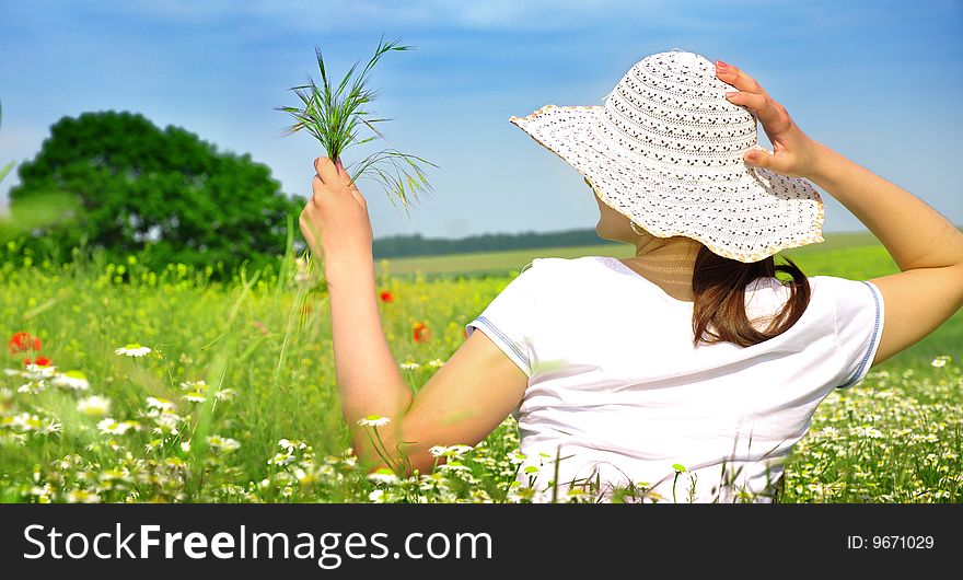 Beautiful girl handing bouquet in the meadow and relaxing. Beautiful girl handing bouquet in the meadow and relaxing