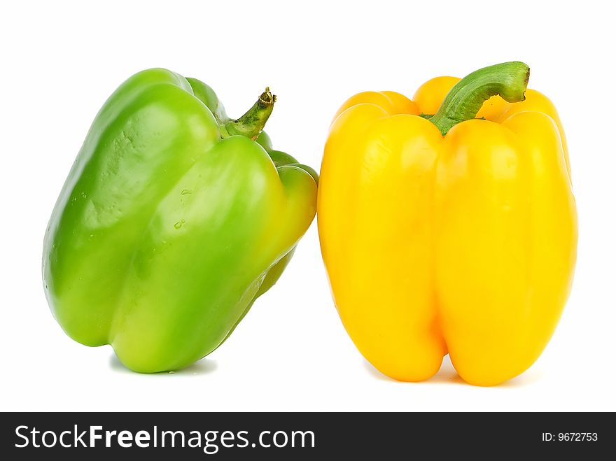 Two of brightly colored capsicums paprika isolated on white. Two of brightly colored capsicums paprika isolated on white.
