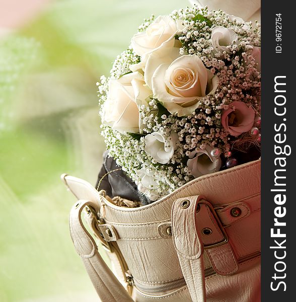 Wedding bouquet in woman bag with outdoor on the background. Wedding bouquet in woman bag with outdoor on the background