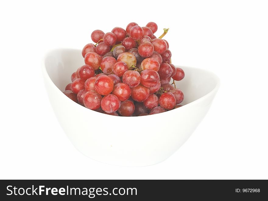 Red grapes in  big china bowl isolated on the white background. Red grapes in  big china bowl isolated on the white background.