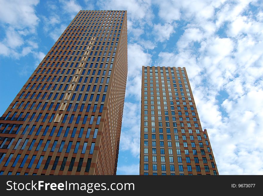 Two brown Office Buildings with a blue sky. Two brown Office Buildings with a blue sky