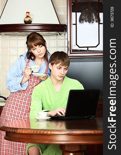 Happy young couple on a kitchen at home. Happy young couple on a kitchen at home.