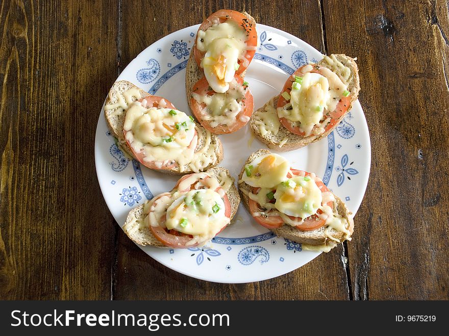 Sandwiches with melted cheese, tomatoes and eggs