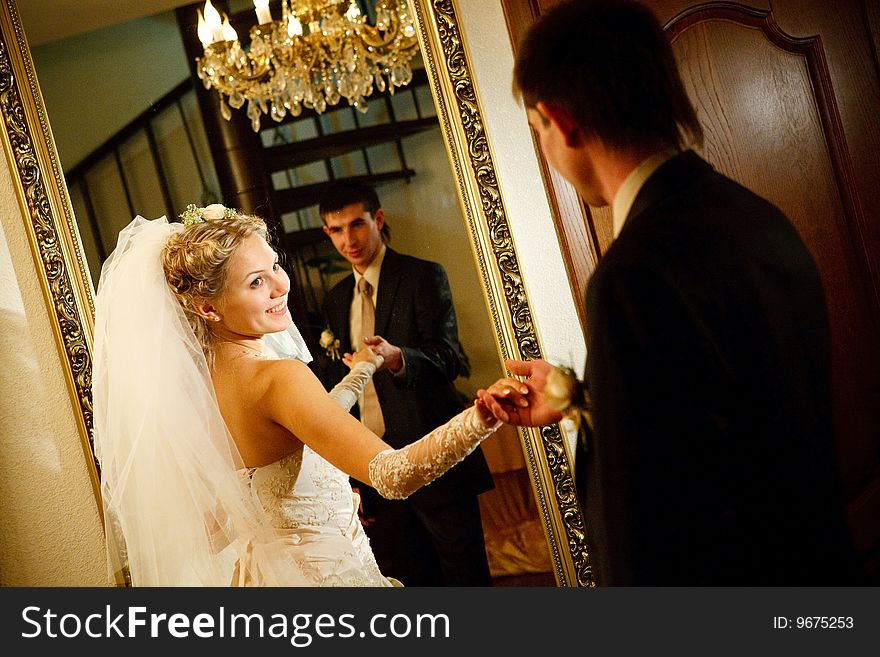 Bride and groom by the mirror