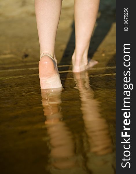 Girl's barefoot legs in the river. Girl's barefoot legs in the river