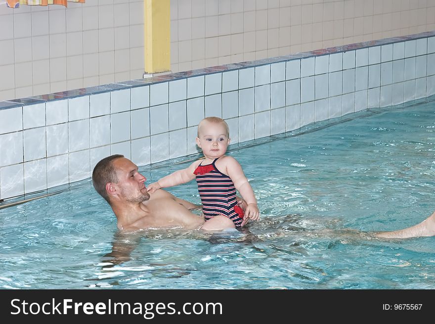 Father with daughter in swimming pool